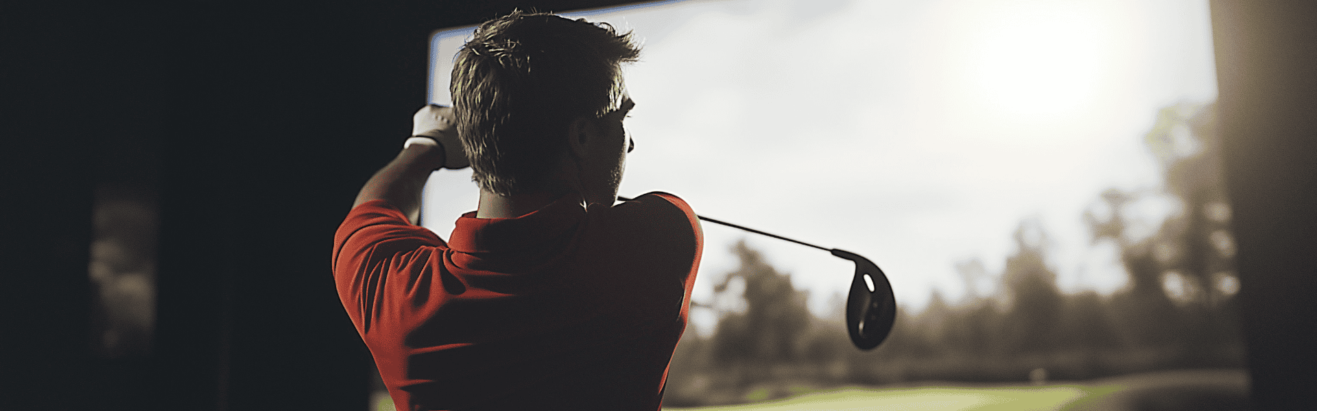 Golfer Finishing Swing Against Simulator Backlight